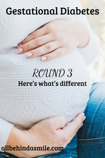 Pregnant belly covered in white sweater with the text Gestational Diabetes Round 3 Here's what's different